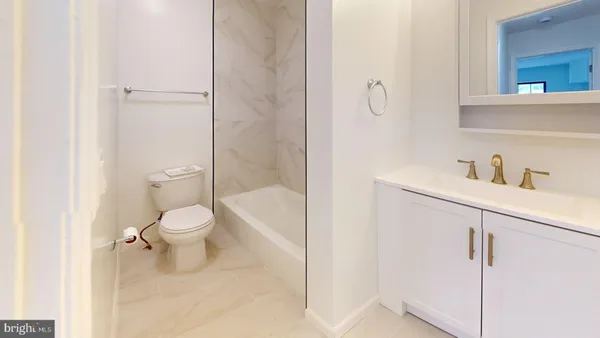 a white toilet sitting next to a bathroom sink