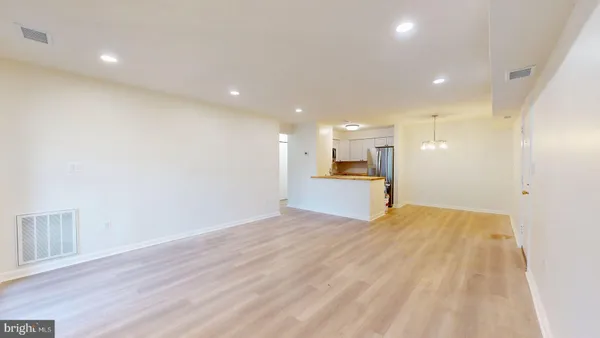 a view of a kitchen with a sink and a refrigerator