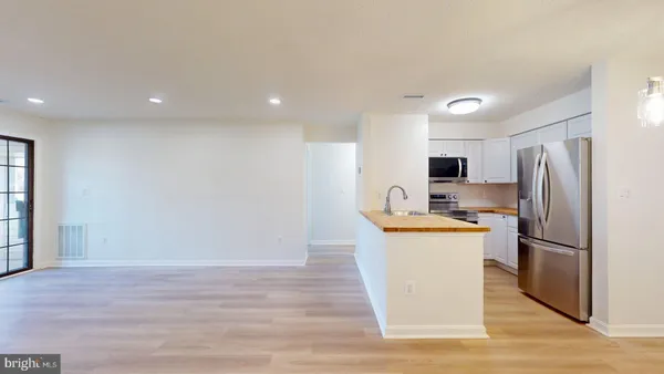 a kitchen with stainless steel appliances a refrigerator sink and stove