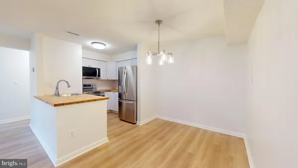 a kitchen with a sink a refrigerator a stove and a window