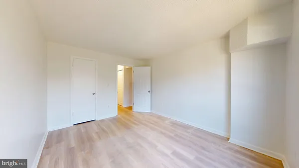 a view of an empty room and wooden floor