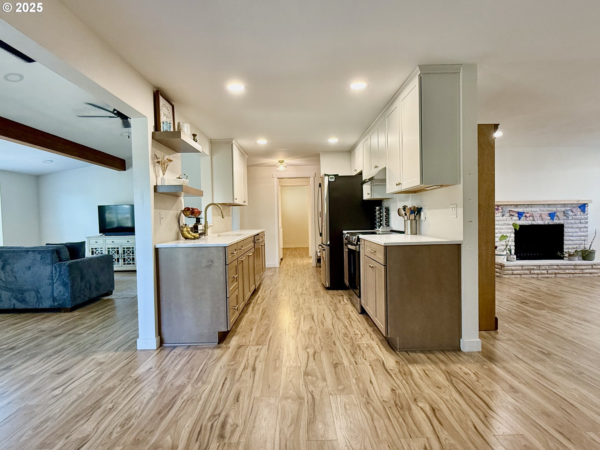 1275 Island Street Springfield, OR 97477 - Photo 9 of 36 a view of a kitchen with kitchen island wooden floors stainless steel appliances