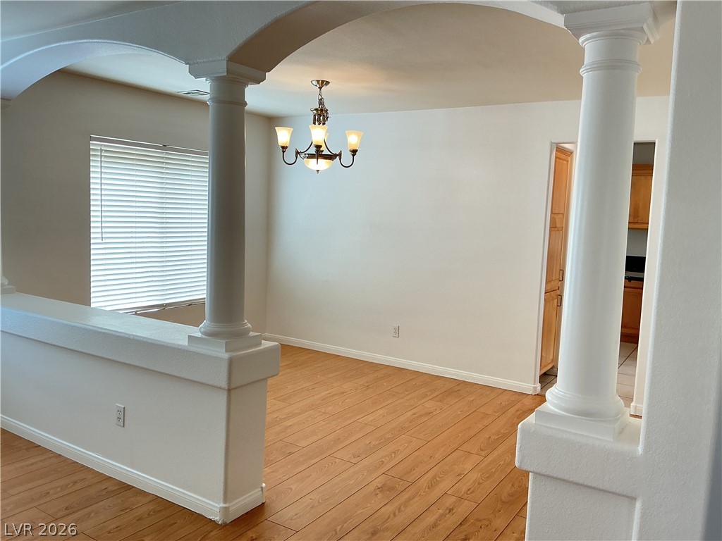 10975 Calcedonian Street Las Vegas, NV 89141 - Photo 6 of 25 This inviting space features elegant architectural details and rich wood flooring, perfect for gatherings.