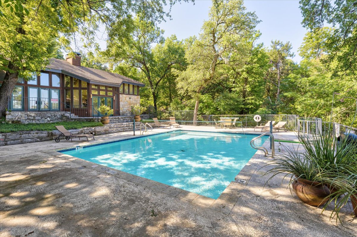 4711 Spicewood Springs Road, Unit 4222 Austin, TX 78759 - Photo 30 of 35 An inviting pool, set within a lush, verdant landscape.