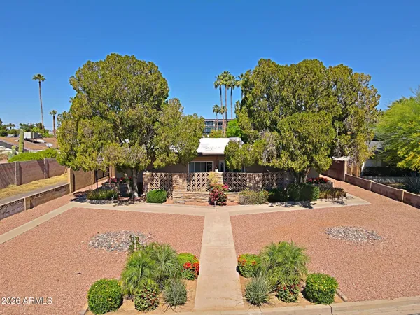 a view of a street with brick wall and building