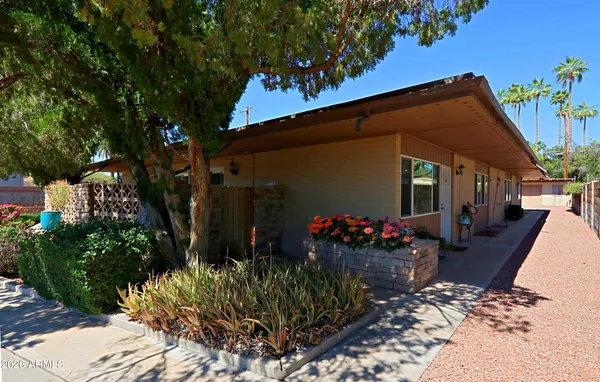 a front view of a building with parking area