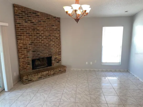 a view of a chandelier fan and entryway
