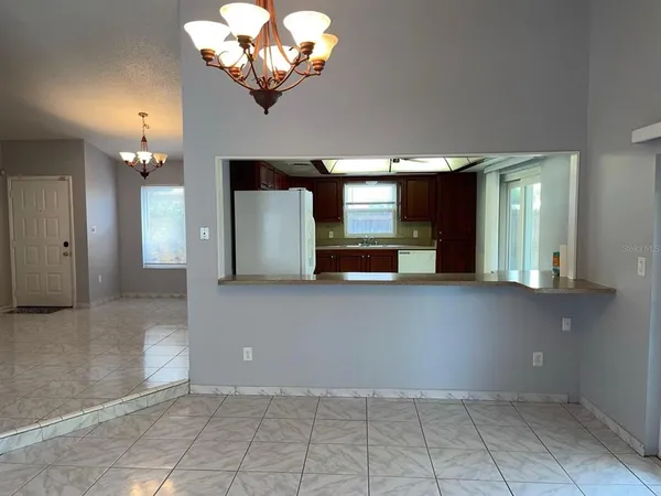 a view of a hallway with some cabinets