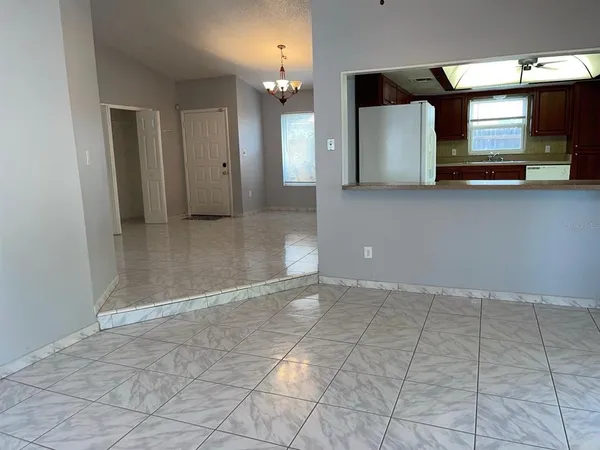 a kitchen with stainless steel appliances granite countertop a refrigerator and a stove