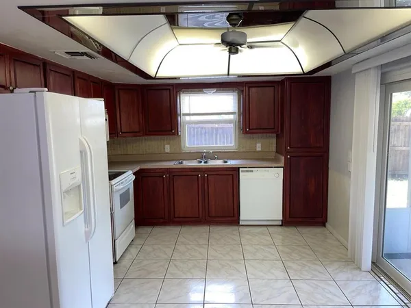 a kitchen with stainless steel appliances granite countertop a refrigerator a sink and dishwasher