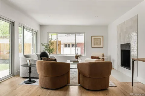 a living room with furniture and large windows