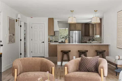a living room with furniture and a chandelier