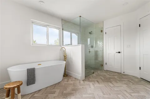 a bathroom with a tub and shower
