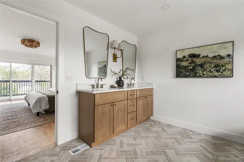 a bathroom with a double vanity sink and mirror