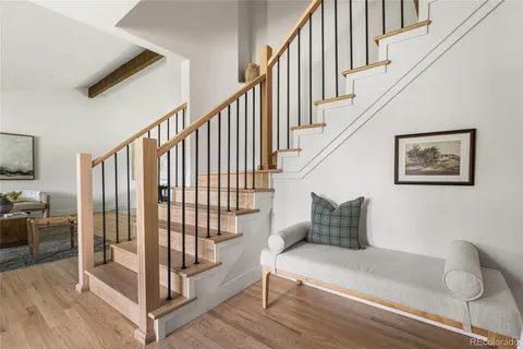 a bedroom with furniture and wooden floor