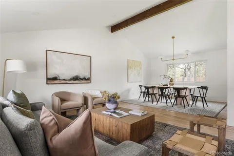 a living room with furniture and a chandelier