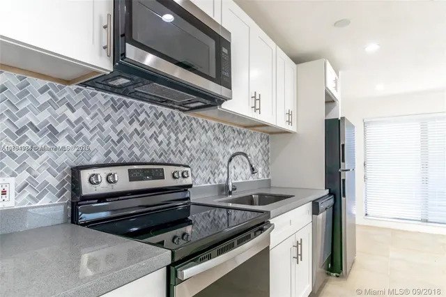 a kitchen with a stove and a microwave