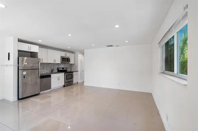 a kitchen with stainless steel appliances a refrigerator and a stove top oven