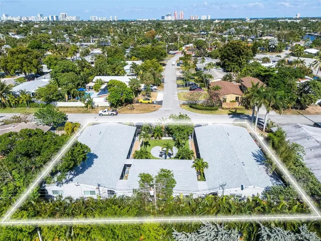 an aerial view of residential houses with outdoor space and street view