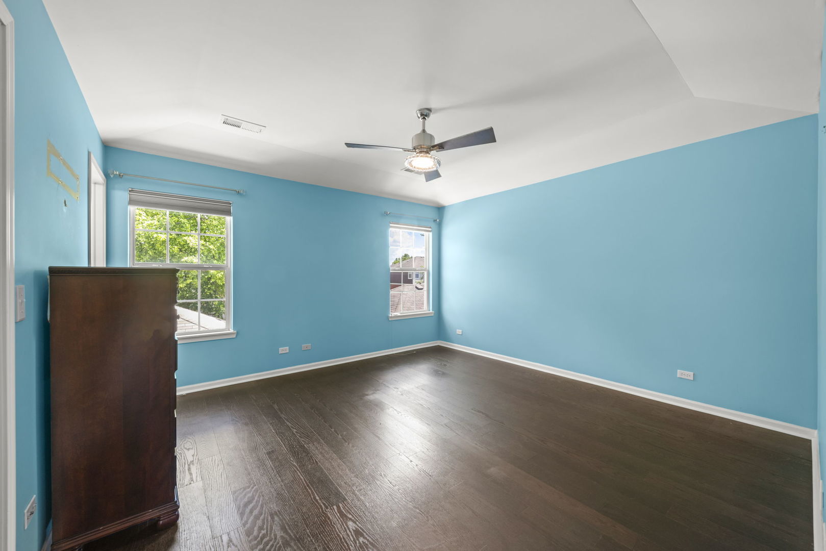 235 Garden Drive Elgin, IL 60124 - Photo 11 of 25 an empty room with wooden floor chandelier fan and windows