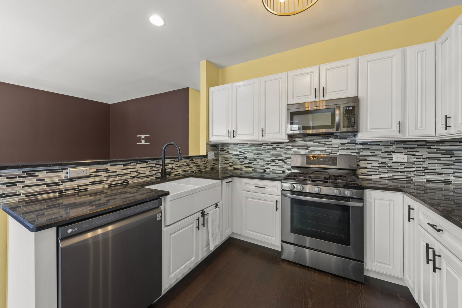 235 Garden Drive Elgin, IL 60124 - Photo 4 of 25 a kitchen with stainless steel appliances granite countertop a stove microwave and sink