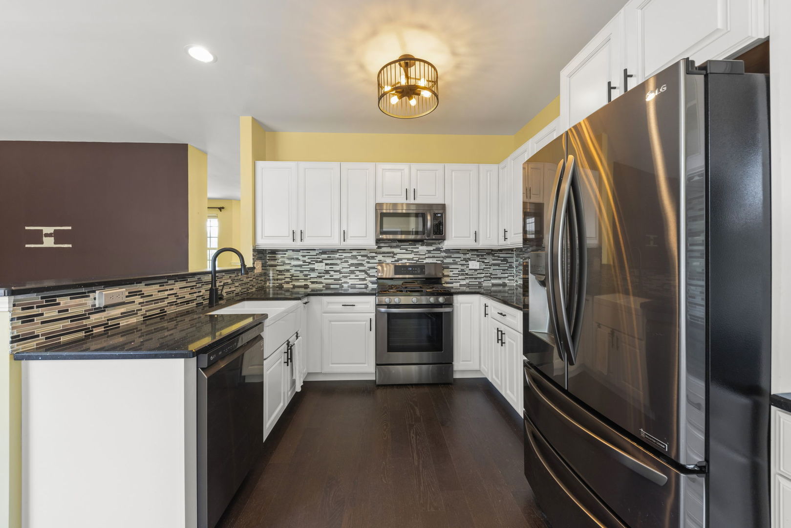 235 Garden Drive Elgin, IL 60124 - Photo 5 of 25 a kitchen with granite countertop a refrigerator stove and microwave