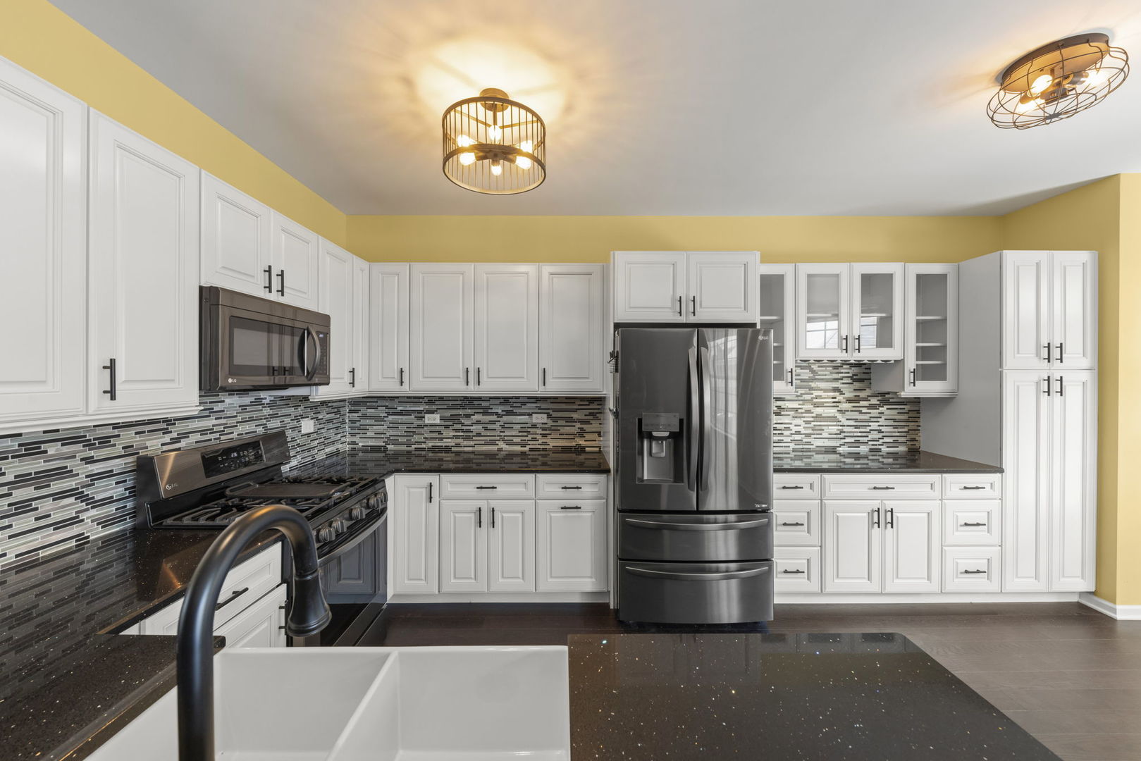 235 Garden Drive Elgin, IL 60124 - Photo 6 of 25 a kitchen with stainless steel appliances granite countertop a stove refrigerator and microwave