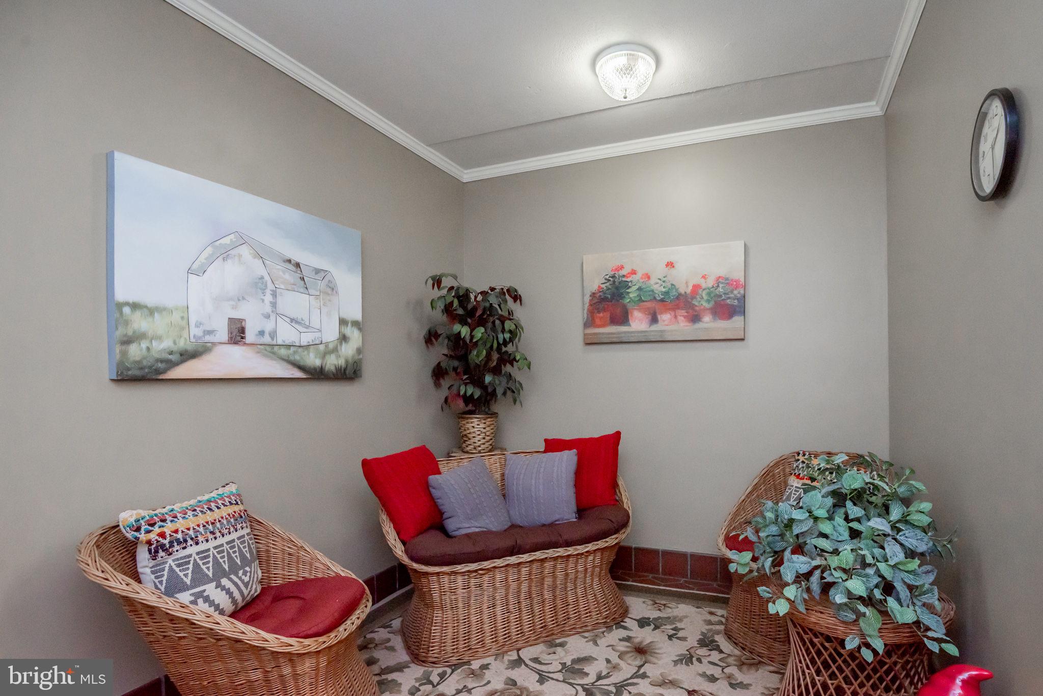 68 Welsh Tract Road, Unit 202 Newark, DE 19713 - Photo 5 of 6 a living room with furniture and a potted plant
