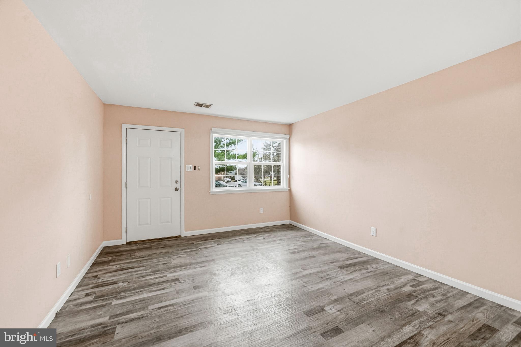 114 Eaves Mill Road Medford, NJ 08055 - Photo 5 of 20 an empty room with wooden floor and windows