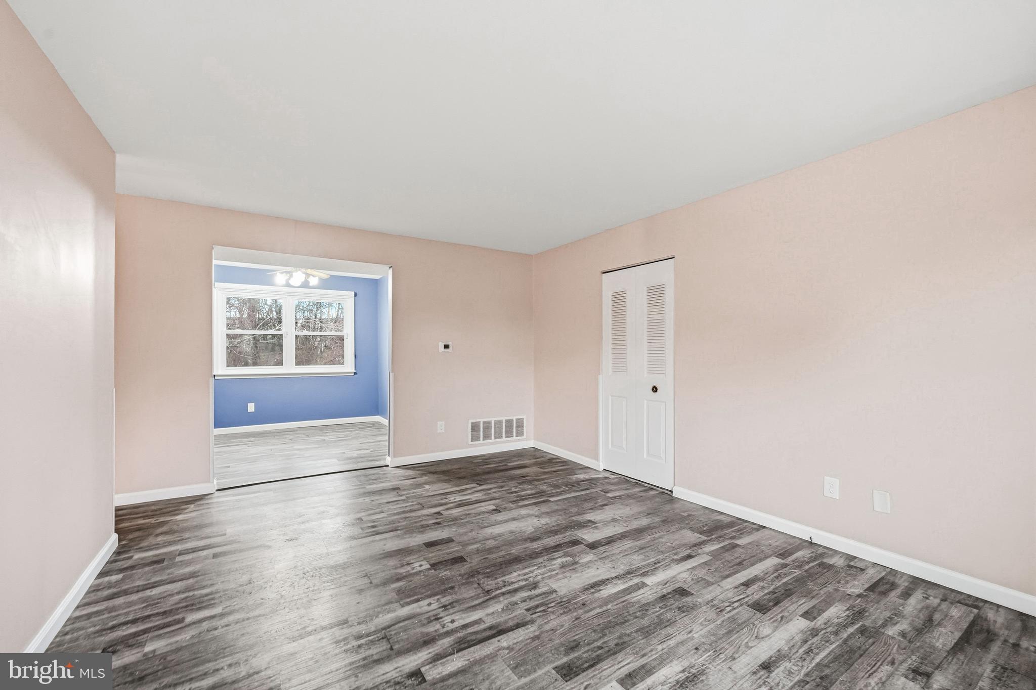 114 Eaves Mill Road Medford, NJ 08055 - Photo 7 of 20 an empty room with wooden floor and windows