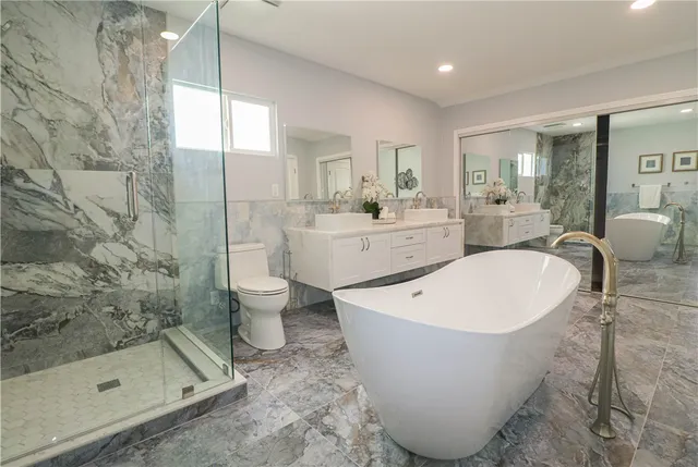 a view of a bathtub in bathroom and a sink