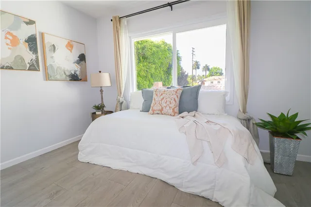 a bed sitting in a bedroom next to a window