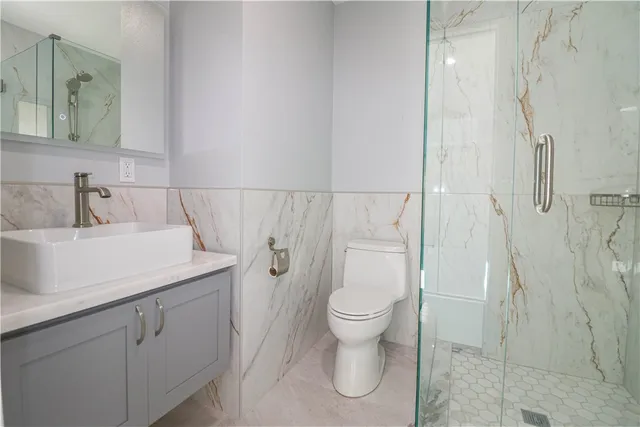 a bathroom with a sink toilet and shower