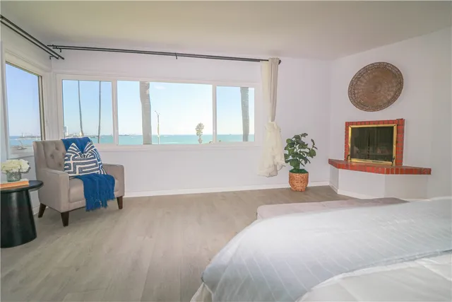 a bedroom with a bed and a potted plant