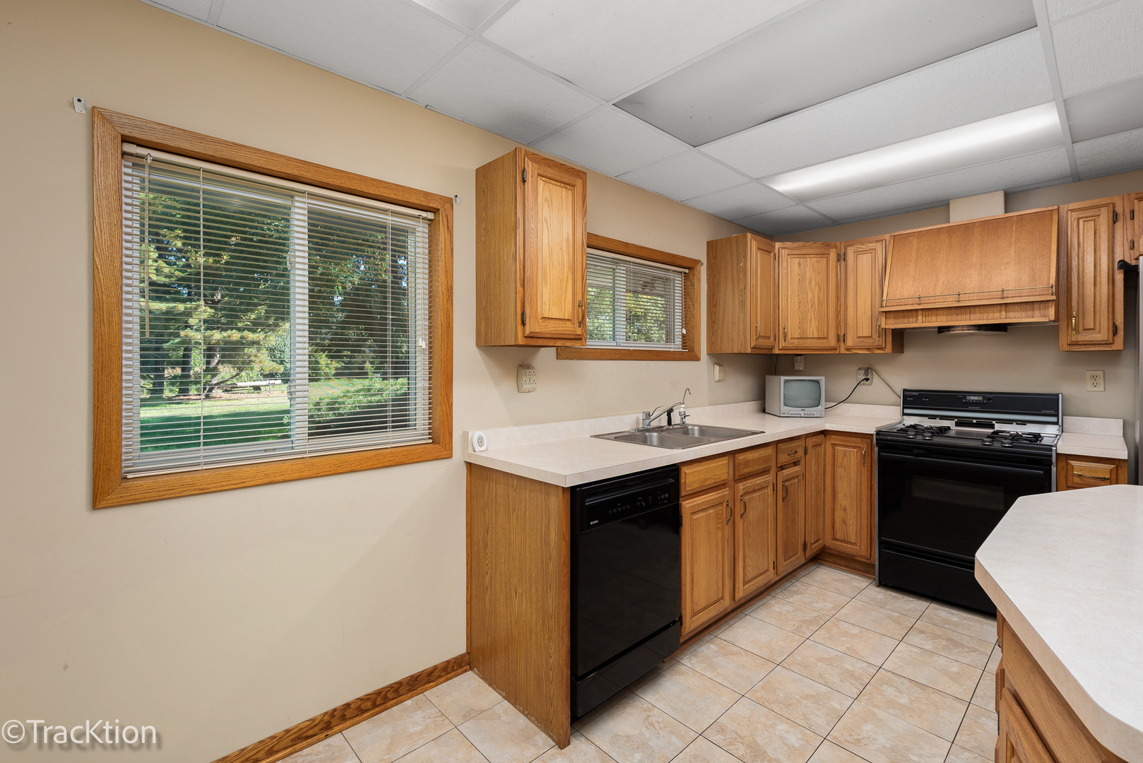 12S440 Lemont Road Lemont, IL 60439 - Photo 7 of 28 a kitchen with stainless steel appliances granite countertop a stove a sink and a refrigerator