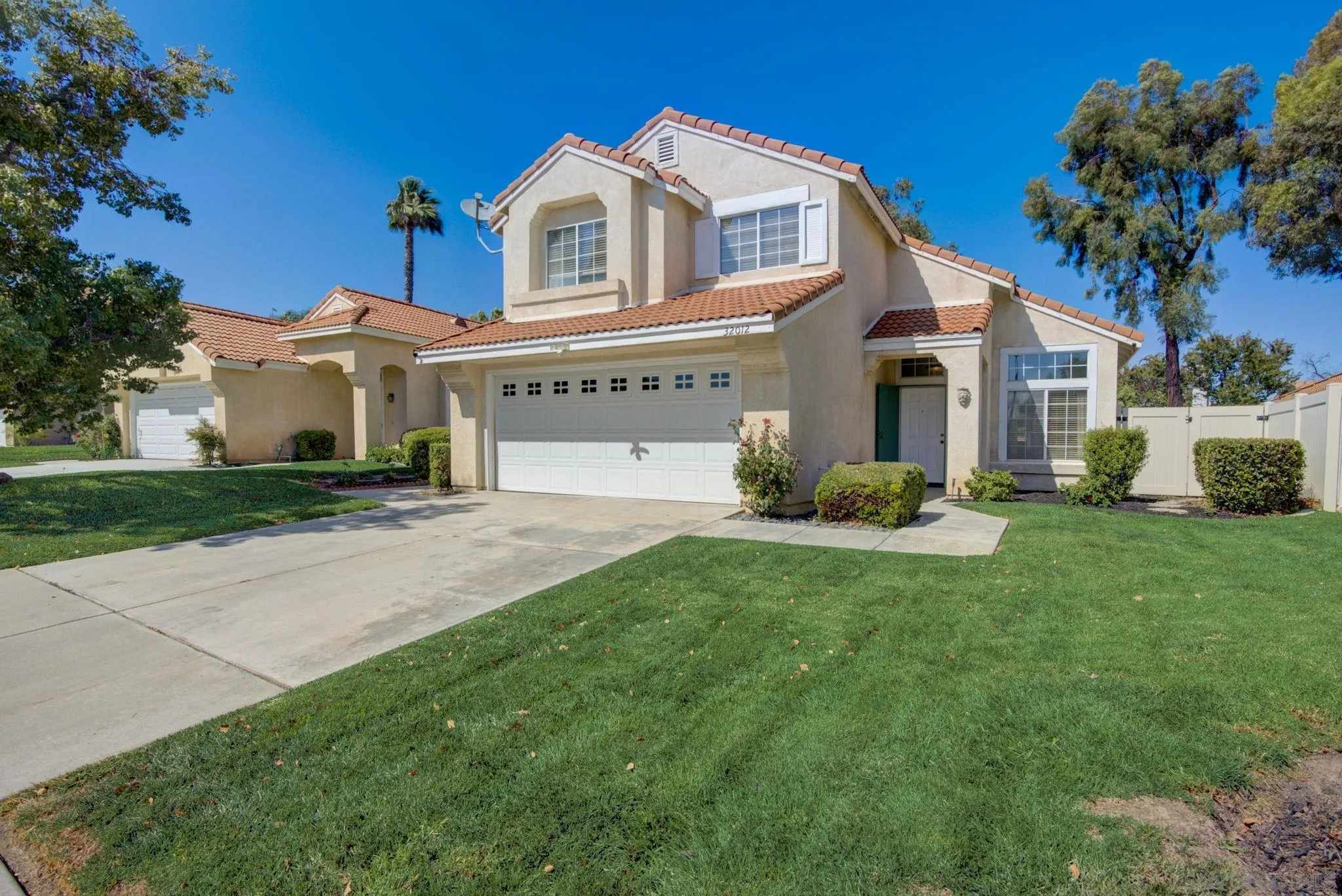 32012 Calle Espinosa Temecula, CA 92592 - Photo 3 of 53 a front view of a house with a yard and garage