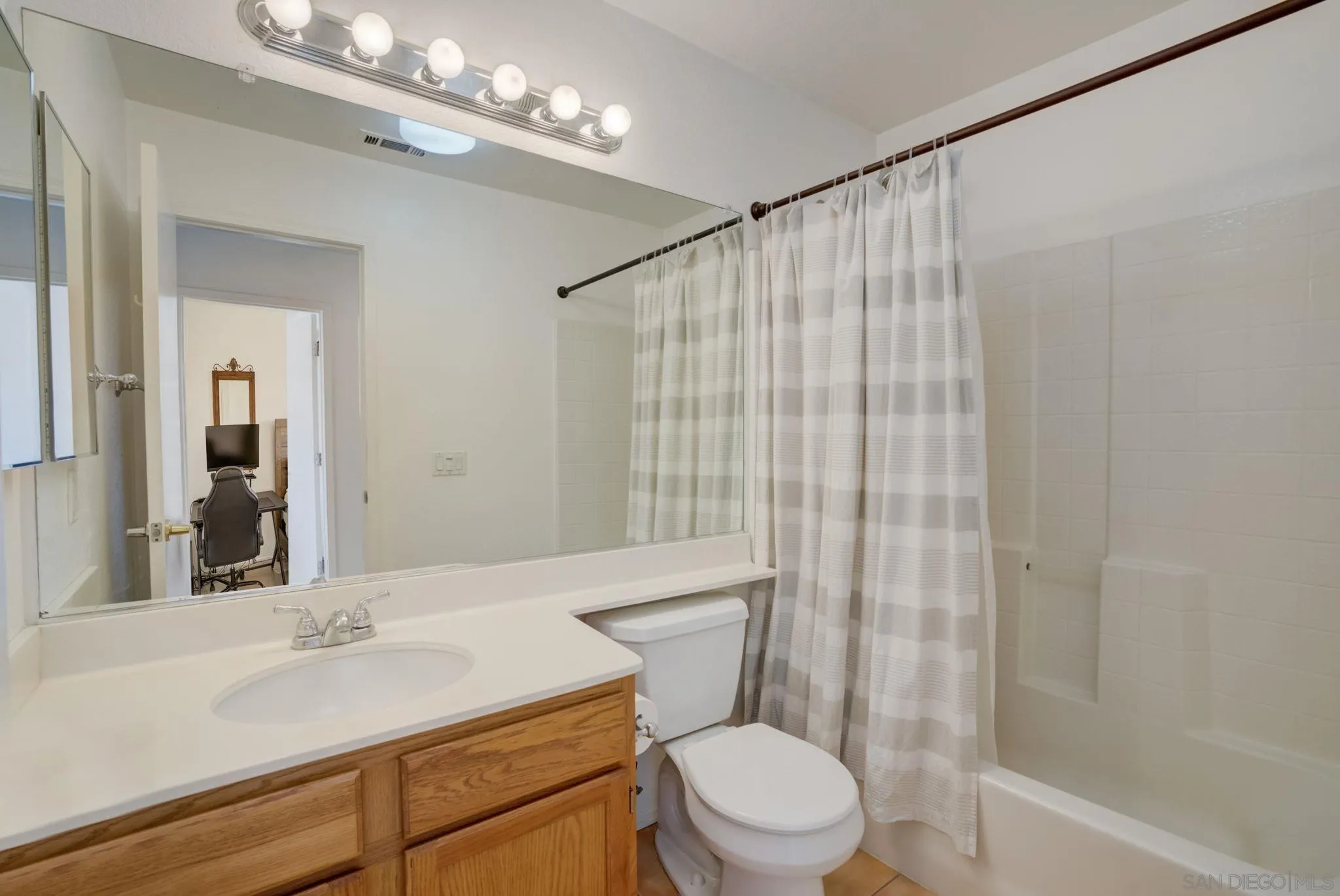 32012 Calle Espinosa Temecula, CA 92592 - Photo 31 of 53 a bathroom with a sink a toilet a mirror and shower