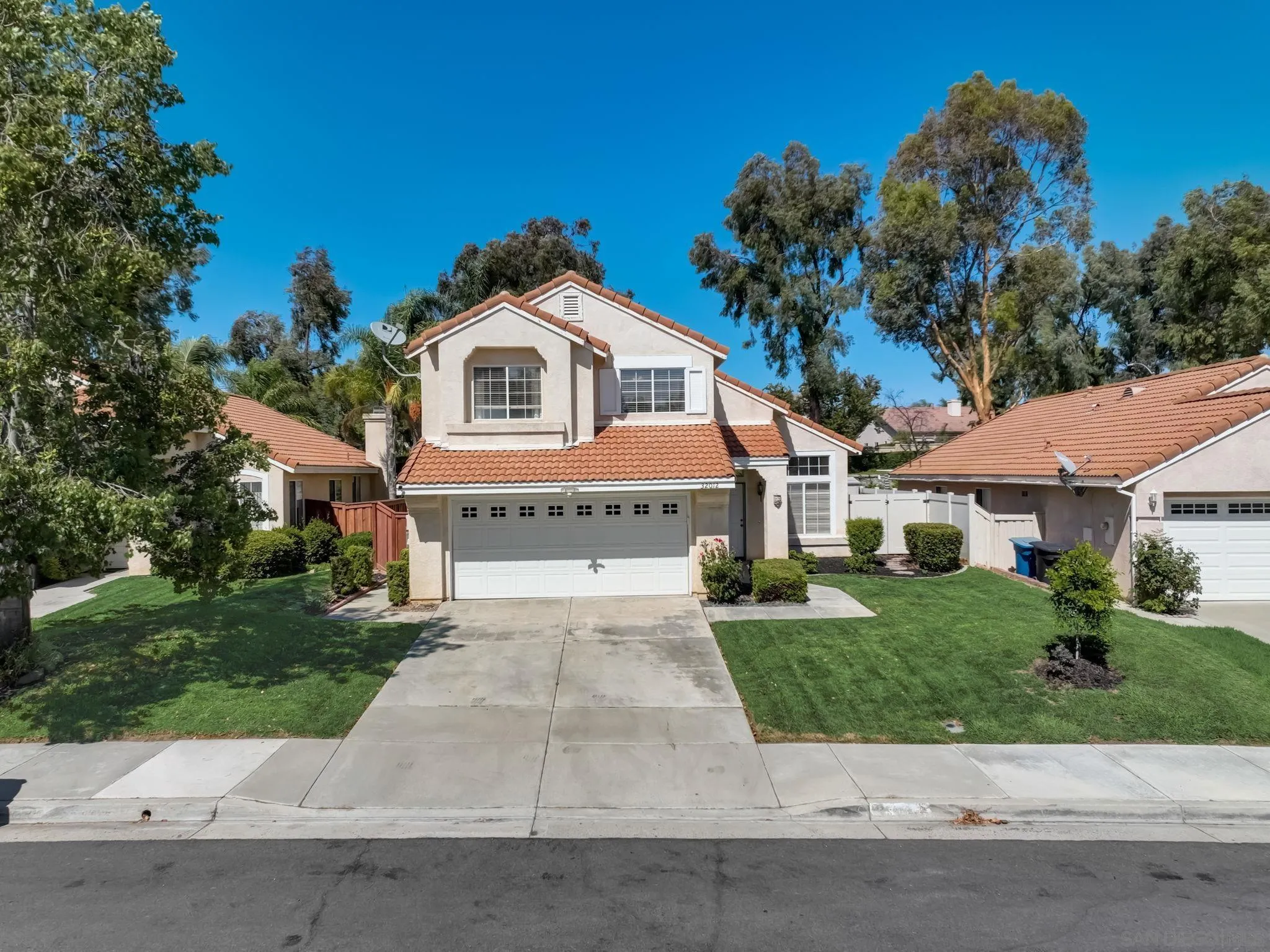 32012 Calle Espinosa Temecula, CA 92592 - Photo 39 of 53 a front view of a house with a garden and trees