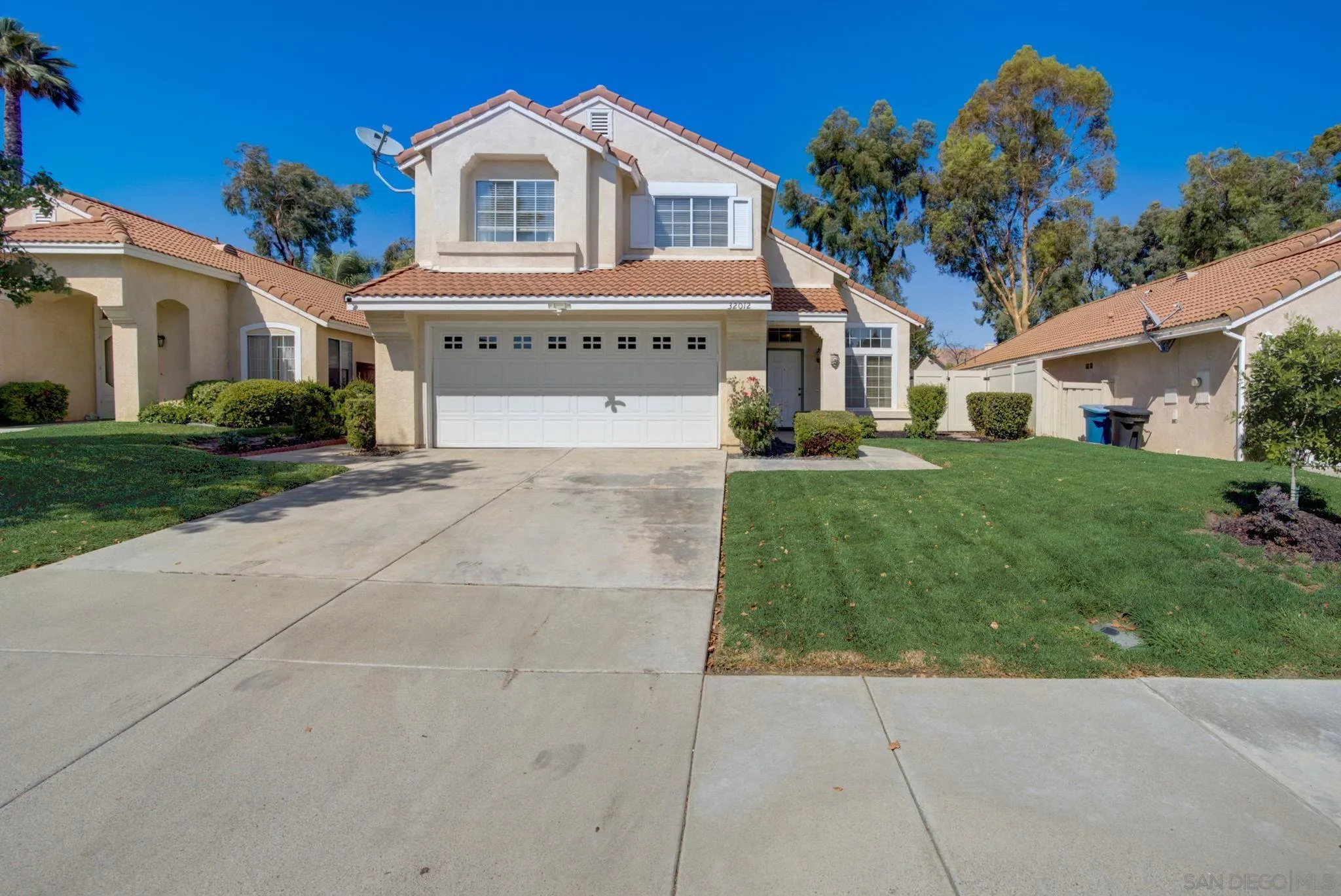 32012 Calle Espinosa Temecula, CA 92592 - Photo 4 of 53 a front view of a house with a garden and trees