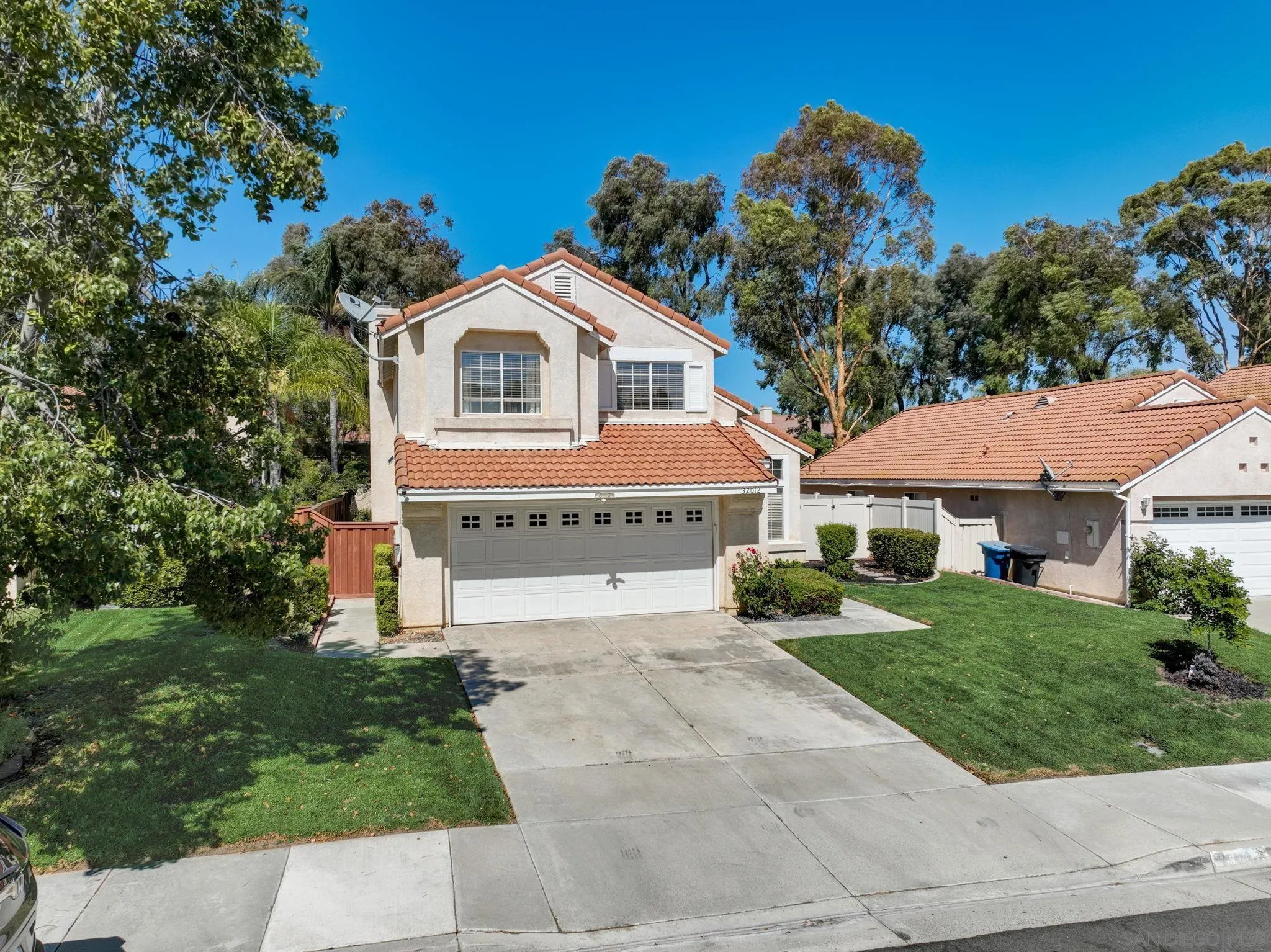 32012 Calle Espinosa Temecula, CA 92592 - Photo 41 of 53 a front view of a house with a yard and potted plants