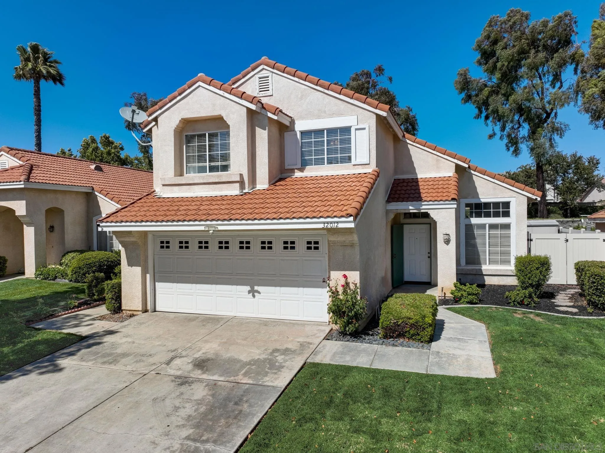 32012 Calle Espinosa Temecula, CA 92592 - Photo 42 of 53 a front view of a house with a yard and garage