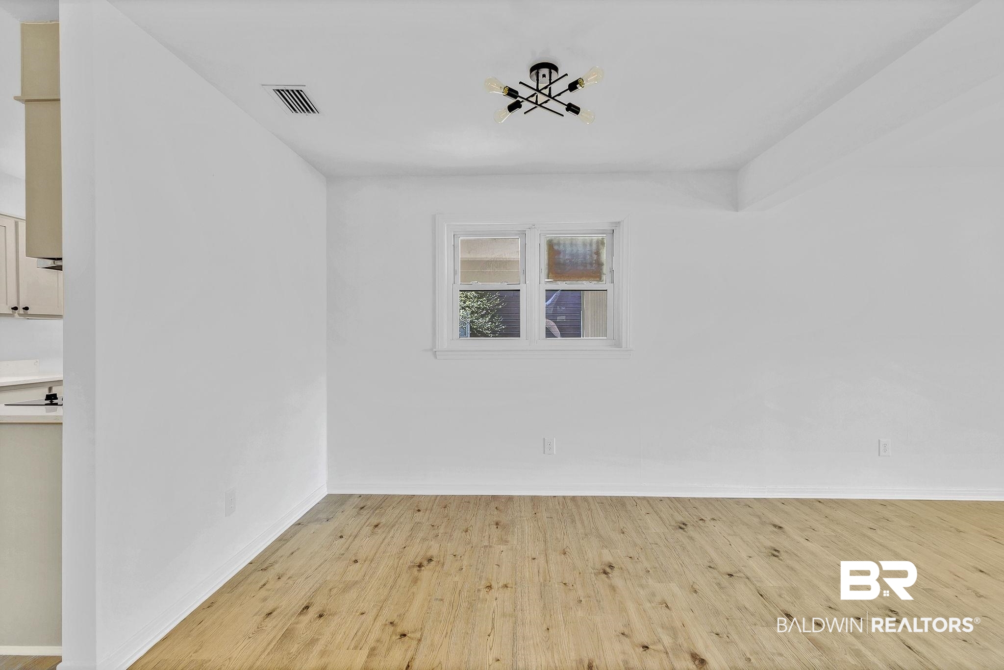 203 Anderson Road Saraland, AL 36571 - Photo 8 of 48 Spare room featuring light wood finished floors, visible vents, and baseboards