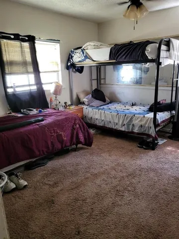 a bedroom with a bed and a mirror