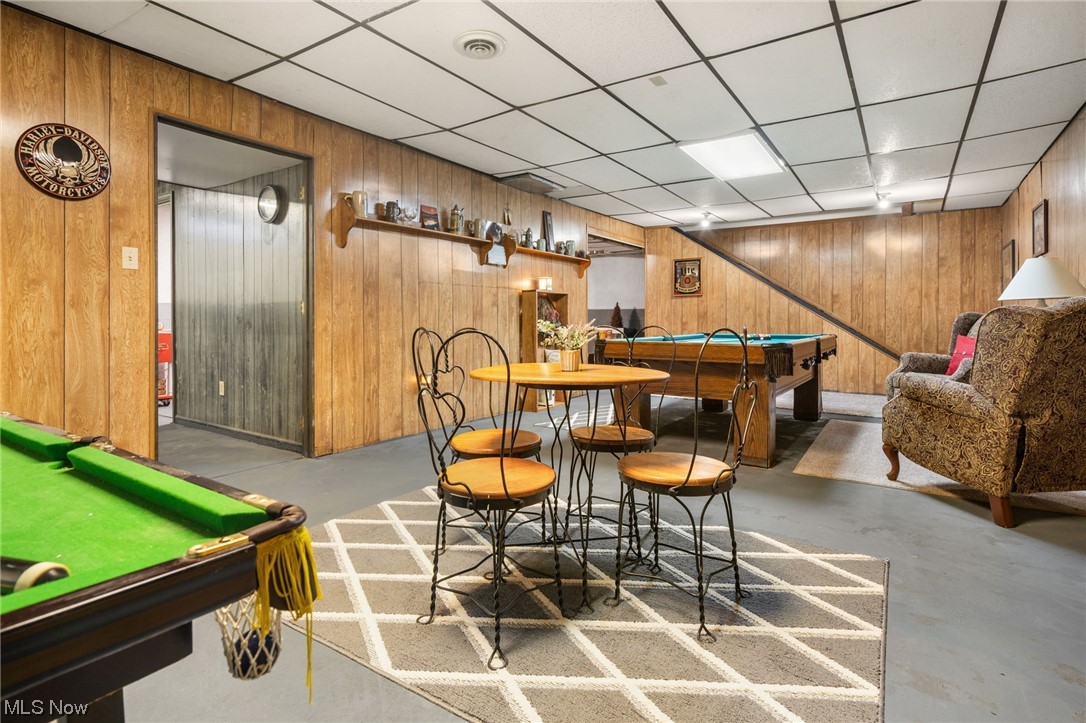 4398 Plymouth Springmill Road Shelby, OH 44875 - Photo 27 of 34 Dining room with pool table, wood walls, and a drop ceiling