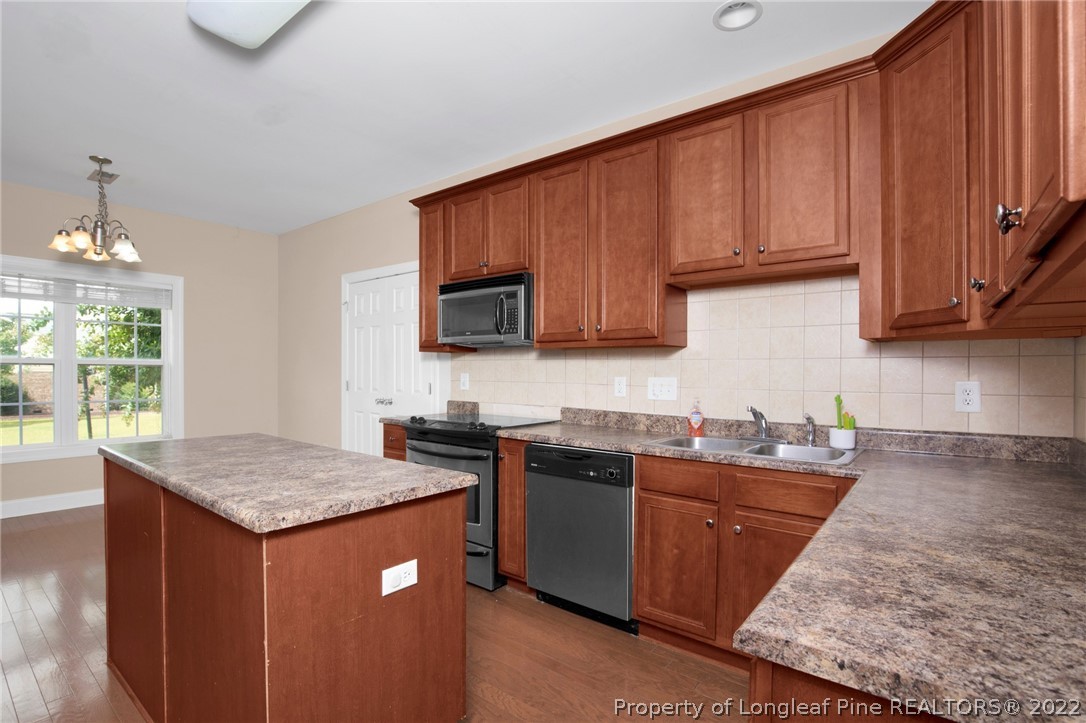 515 Booth Pond Road Raeford, NC 28376 - Photo 15 of 39 a kitchen with stainless steel appliances granite countertop a sink stove and microwave