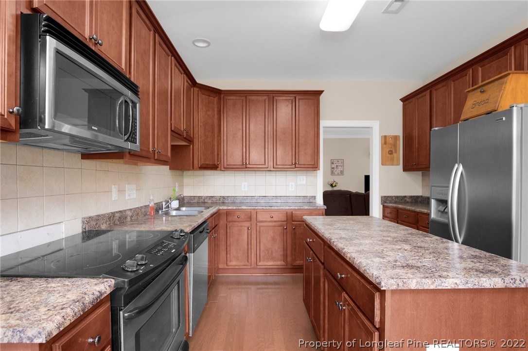 515 Booth Pond Road Raeford, NC 28376 - Photo 17 of 39 a kitchen with stainless steel appliances granite countertop a sink stove and refrigerator