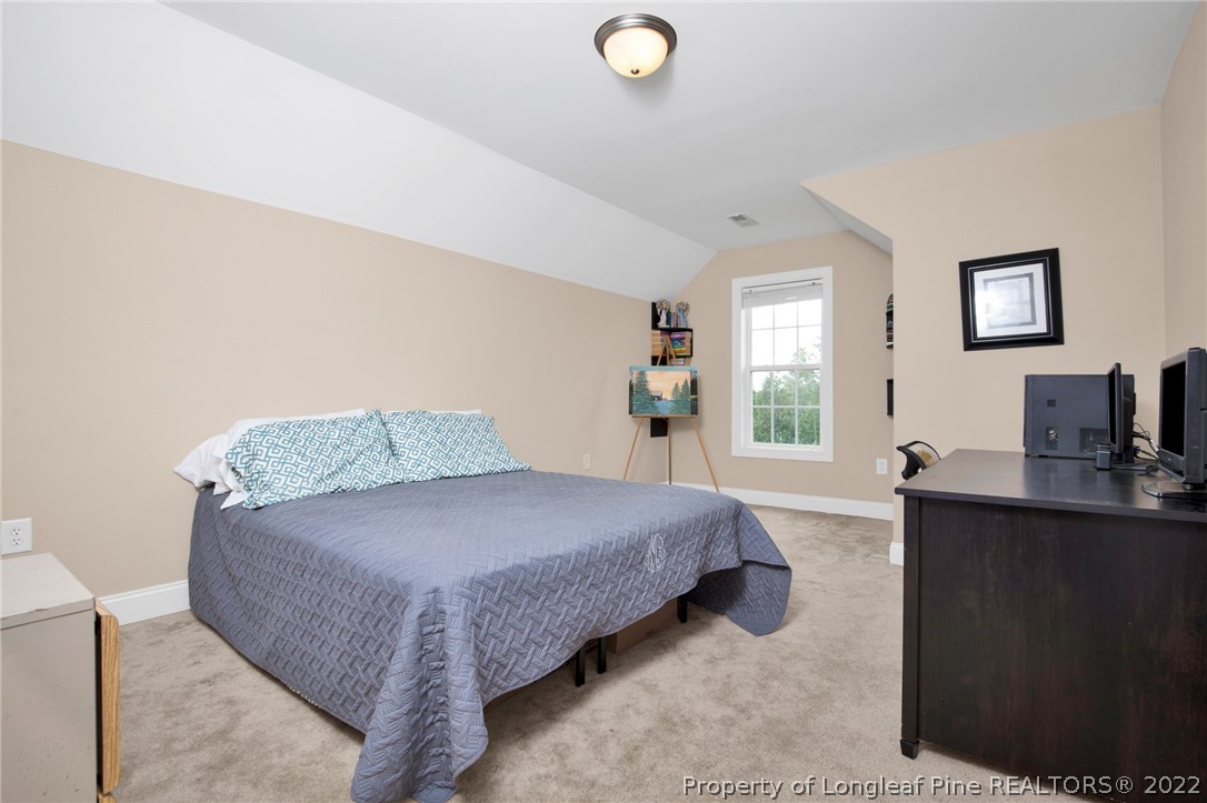 515 Booth Pond Road Raeford, NC 28376 - Photo 24 of 39 a spacious bedroom with a bed and window