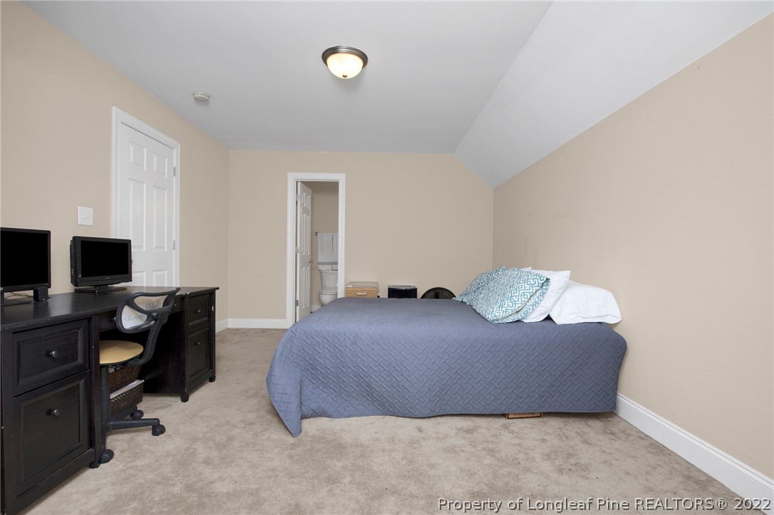 515 Booth Pond Road Raeford, NC 28376 - Photo 25 of 39 a bedroom with a bed and flat screen tv