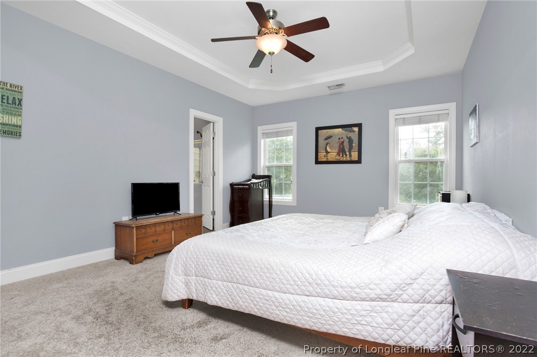 515 Booth Pond Road Raeford, NC 28376 - Photo 28 of 39 a bedroom with a bed and a flat screen tv