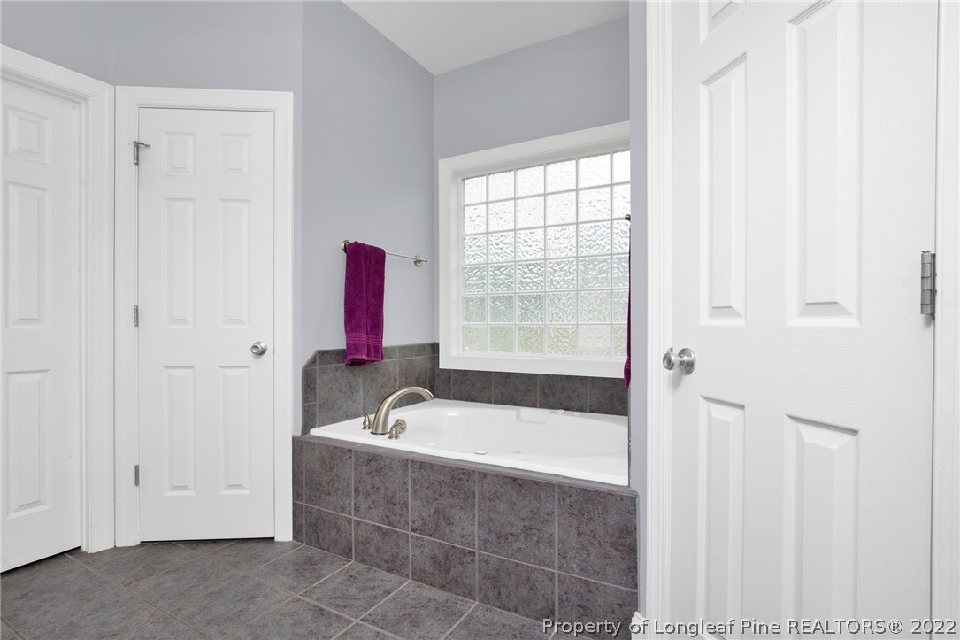 515 Booth Pond Road Raeford, NC 28376 - Photo 30 of 39 a bathroom with a bathtub and a shower